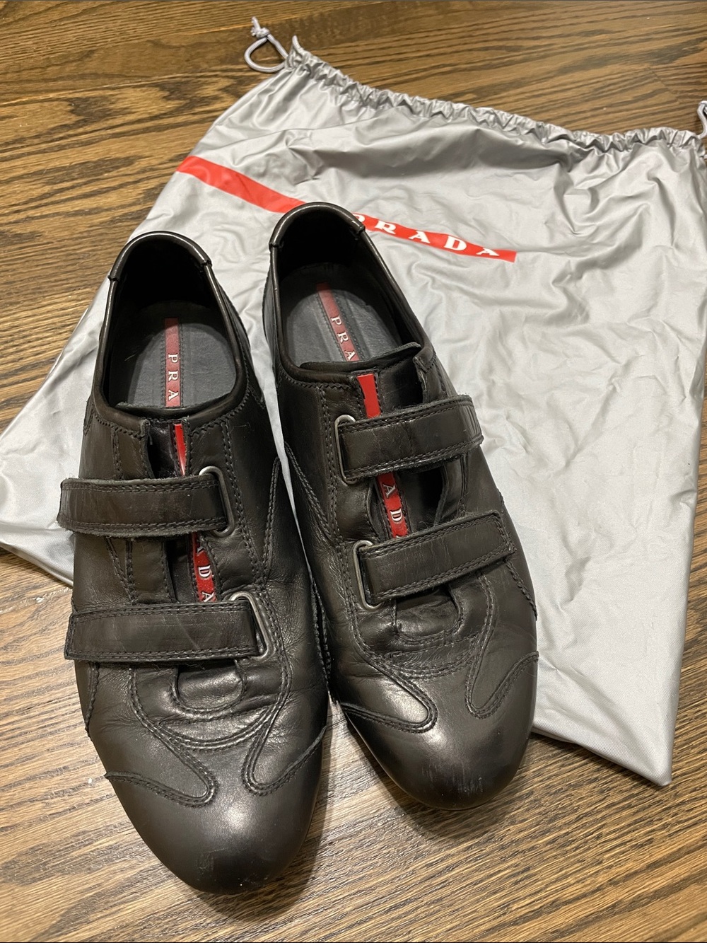 Prada women’s Black Leather Velcro Sneakers with Red Stripe